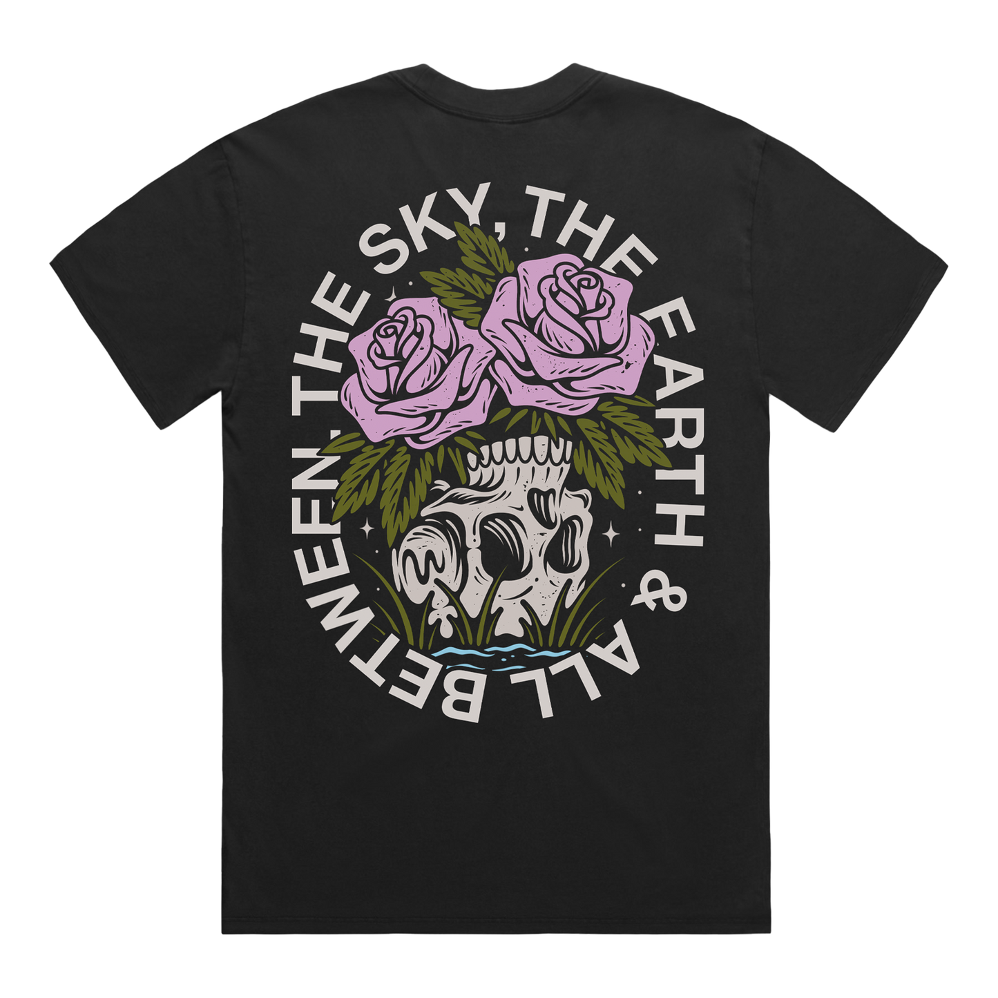 Back of a black short-sleeve t-shirt featuring a flower–skull graphic, with white text around it that reads “The Sky, The Earth & All Between.”