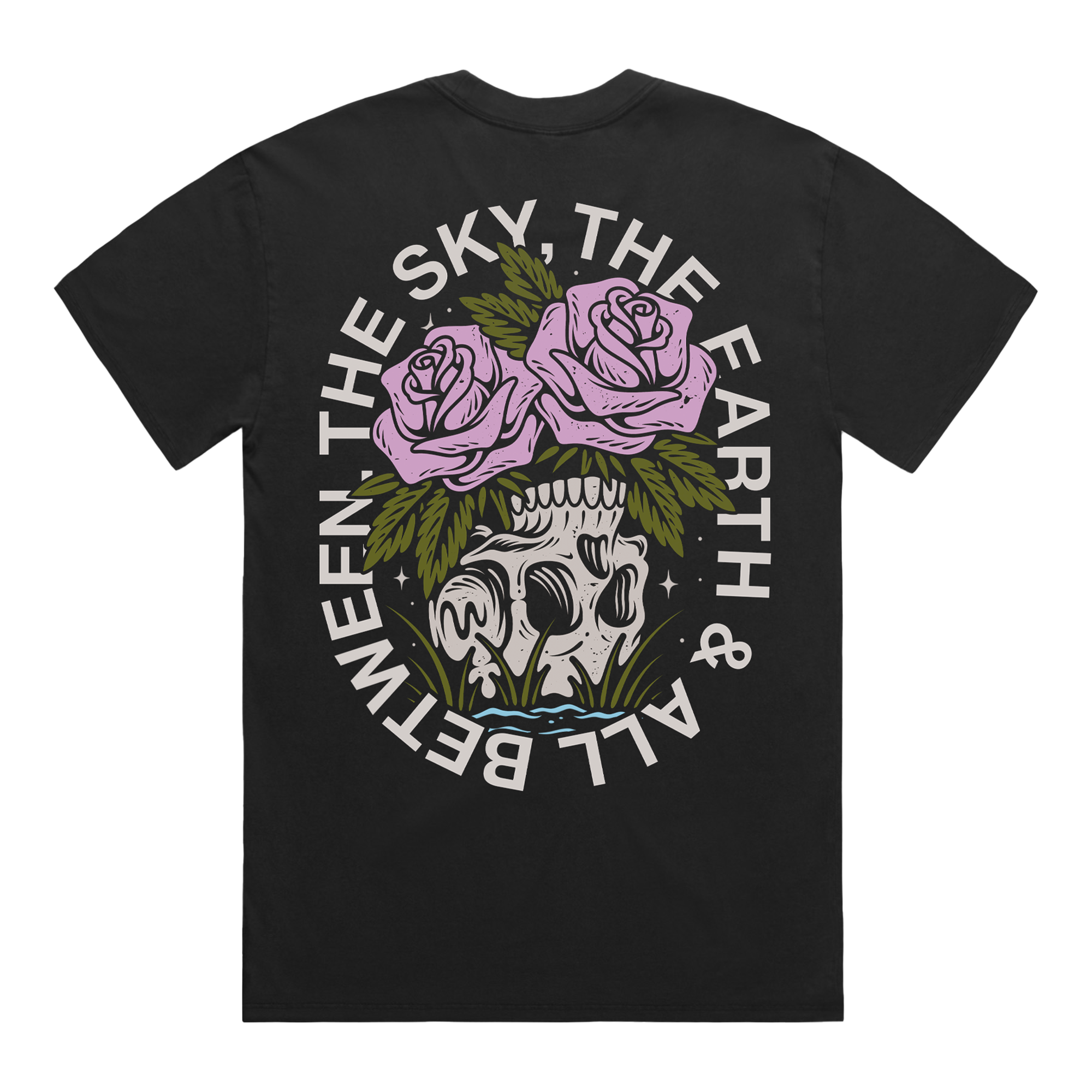 Back of a black short-sleeve t-shirt featuring a flower‚Äìskull graphic, with white text around it that reads ‚ÄúThe Sky, The Earth & All Between.‚Äù